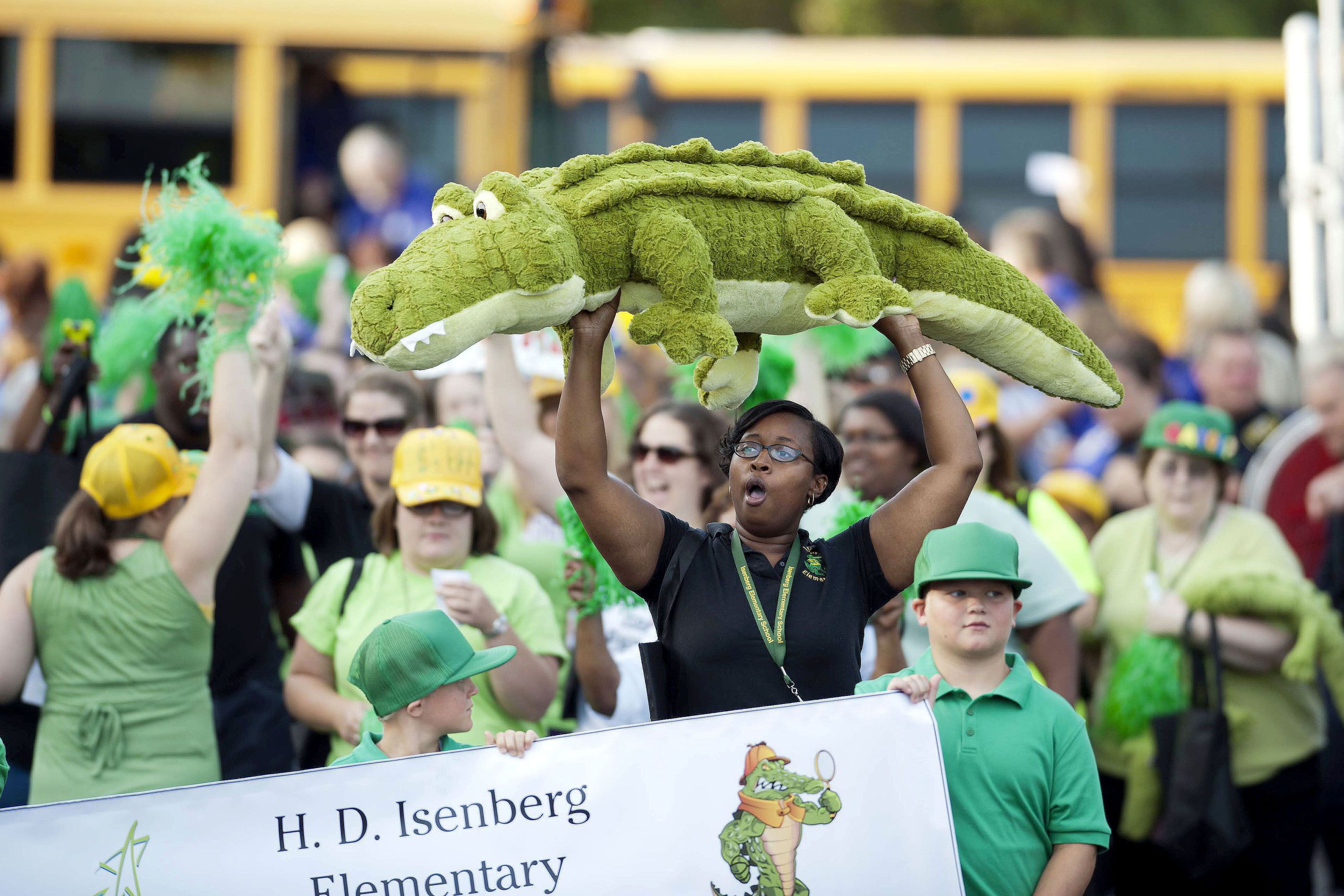 JON C. LAKEY / SALISBURY POST JON C. LAKEY / SALISBURY POST Isenberg Elementary school's 5th grade teacher Asiah Simmons carries a large toy alligator into the stadium The Rowan Salisbury School employees , over 3,000 strong, gathered in the football stadium at North Rowan High School on Thursday morning for the first ever system wide pep rally. Thursday, August 21, 2014, in Spencer, N.C.