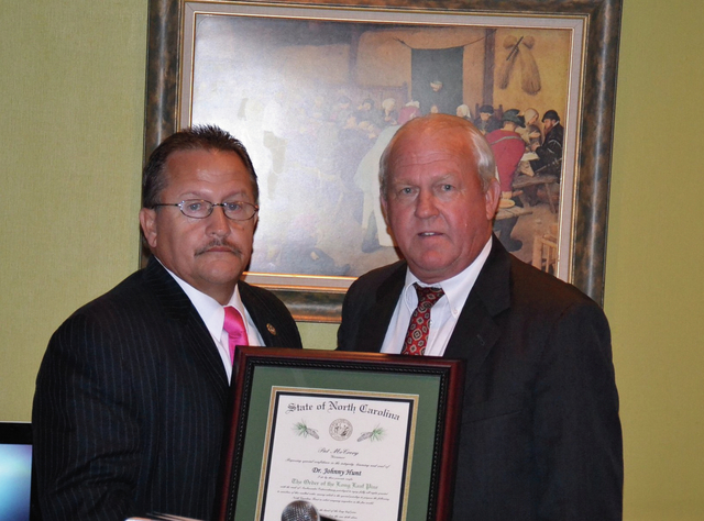 Contributed Photo | Retiring Robeson County school Superintendent Johnny Hunt, left, was presented the Order of the Long Leaf Pine by Mike Smith, vice chairman of the school board, during a banquet Thursday. Conferred by Gov. Pat McCrory, the award is the state's highest civilian honor.